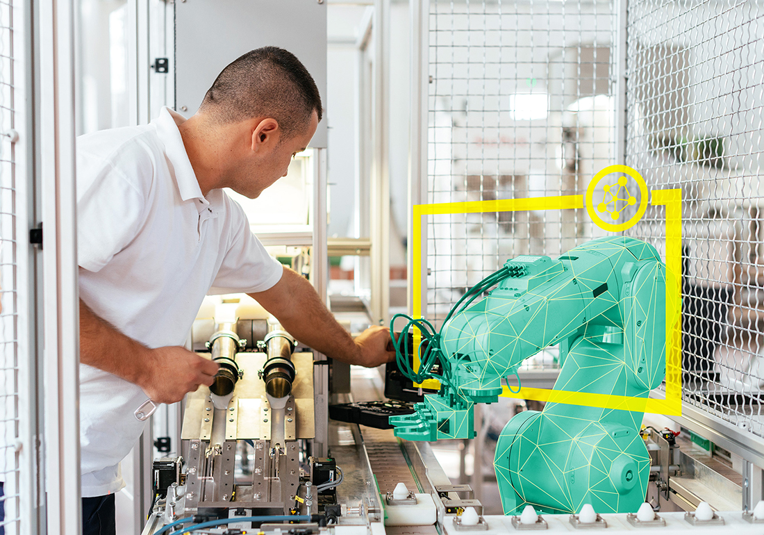 Mitarbeiter kontrolliert Roboter in einer Smart Factory